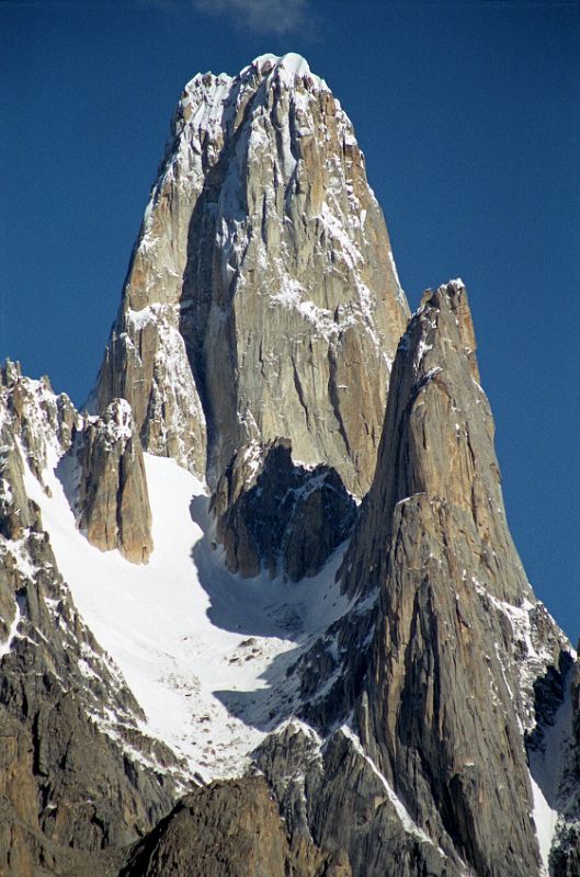 13 Uli Biaho Tower Close Up From Khoburtse Just After Sunrise Uli Biaho Tower shines in the early morning sun from Khoburtse. The first ascent of Uli Biaho Tower (6109m) was made on July 3, 1979 by John Roskelley, Kim Schimtz, Ron Kauk and Bill Forrest via the east face. �One by one, each of us climbed to its broad top, soaked in the evening�s warmth, cried a little, laughed a little, and, for just a few brief moments, forgot the cold, thirst, and danger below.� - Stories Off The Wall by John Roskelley.